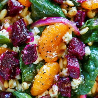 Healthy beet salad with spinach and feta cheese served in a bowl