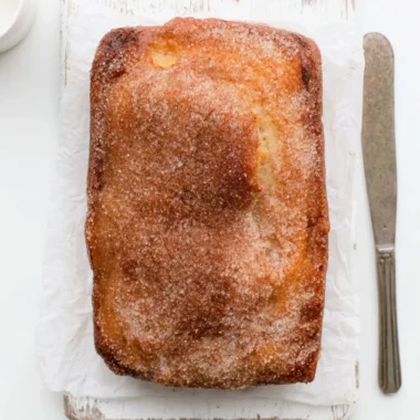 Loaf of cinnamon sugar donut bread, freshly baked and sliced.
