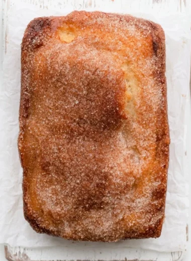 Loaf of cinnamon sugar donut bread, freshly baked and sliced.