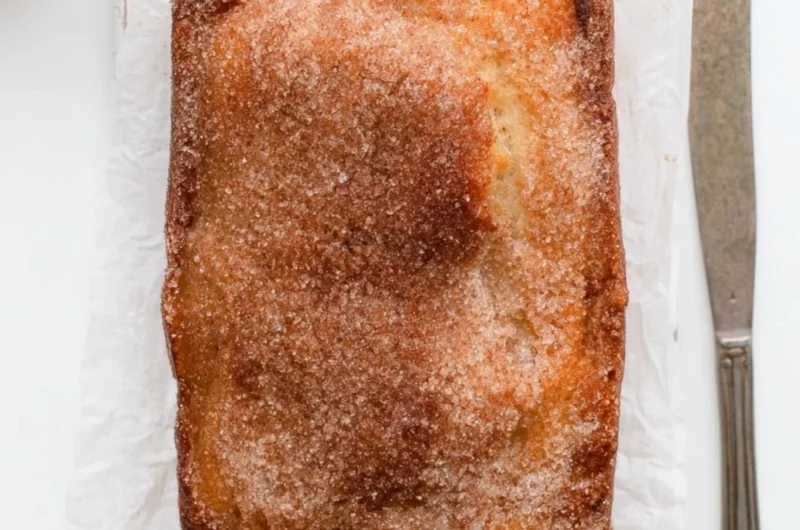 Loaf of cinnamon sugar donut bread, freshly baked and sliced.