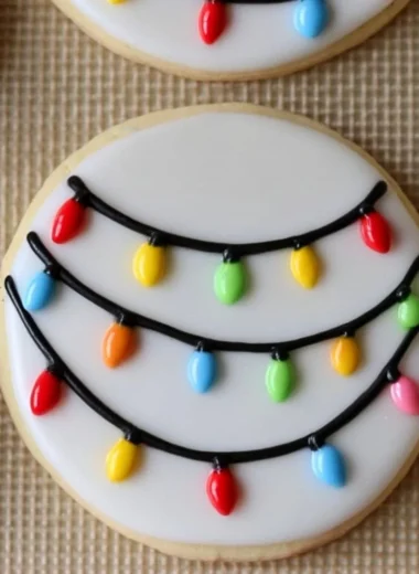 Cozy Christmas lights decorated royal icing sugar cookies on a festive table