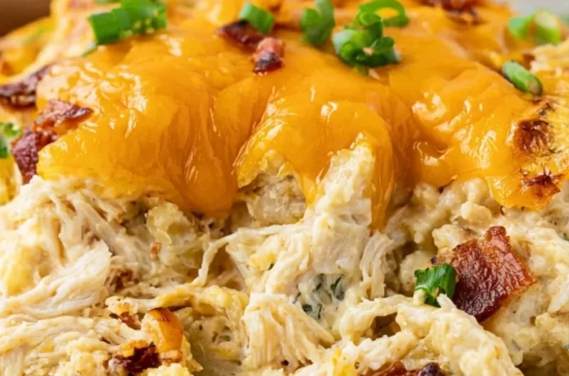 Cozy Crack Chicken Casserole topped with cheese and herbs in a baking dish
