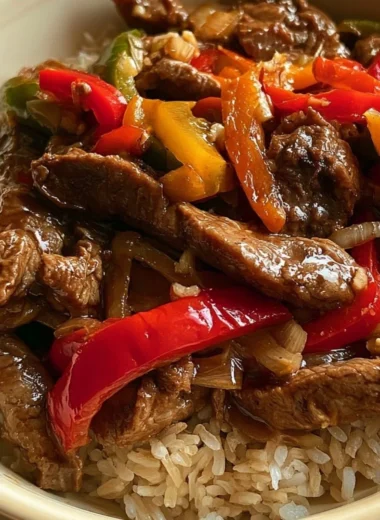 Cozy slow cooker pepper steak dish served with vegetables