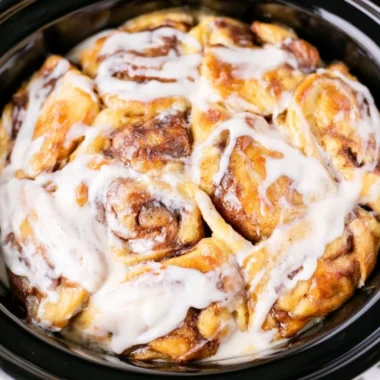 Delicious crockpot cinnamon roll casserole served warm and gooey.
