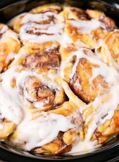 Delicious crockpot cinnamon roll casserole served warm and gooey.