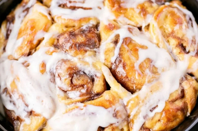 Delicious crockpot cinnamon roll casserole served warm and gooey.