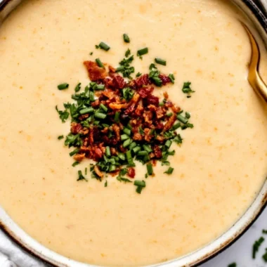 High-protein cream of protein soup served in a bowl with fresh herbs.