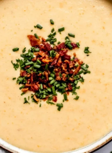 High-protein cream of protein soup served in a bowl with fresh herbs.