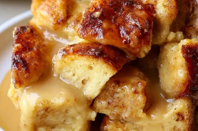 Delicious bread pudding served with rich vanilla caramel sauce and garnished.