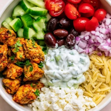 High-protein chicken gyro bowl with fresh vegetables and sauce