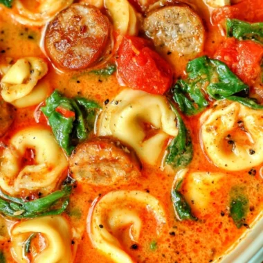 Bowl of Healthy Tortellini Soup with colorful vegetables and fresh herbs
