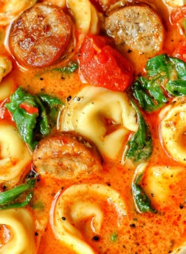 Bowl of Healthy Tortellini Soup with colorful vegetables and fresh herbs