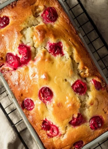 Mom's Cranberry Walnut Bread fresh from the oven, showcasing cranberries and walnuts.