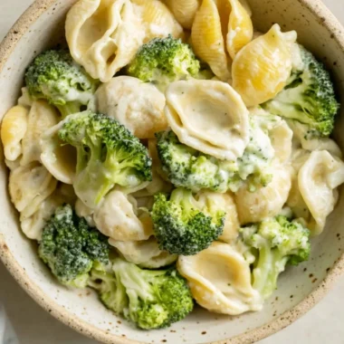 Delicious one pot broccoli pasta served in a bowl with fresh broccoli and parmesan cheese
