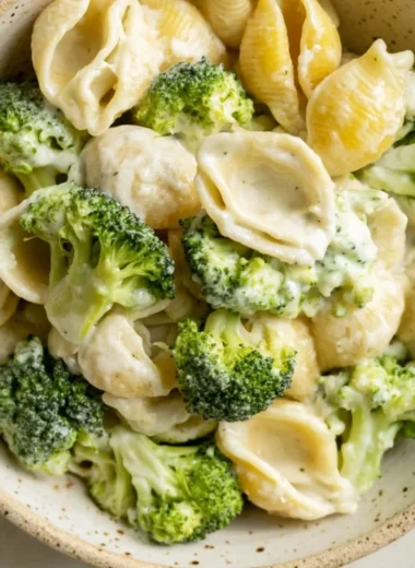 Delicious one pot broccoli pasta served in a bowl with fresh broccoli and parmesan cheese