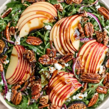 Delicious apple arugula salad with fresh ingredients and vibrant colors.