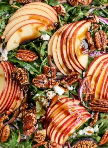 Delicious apple arugula salad with fresh ingredients and vibrant colors.