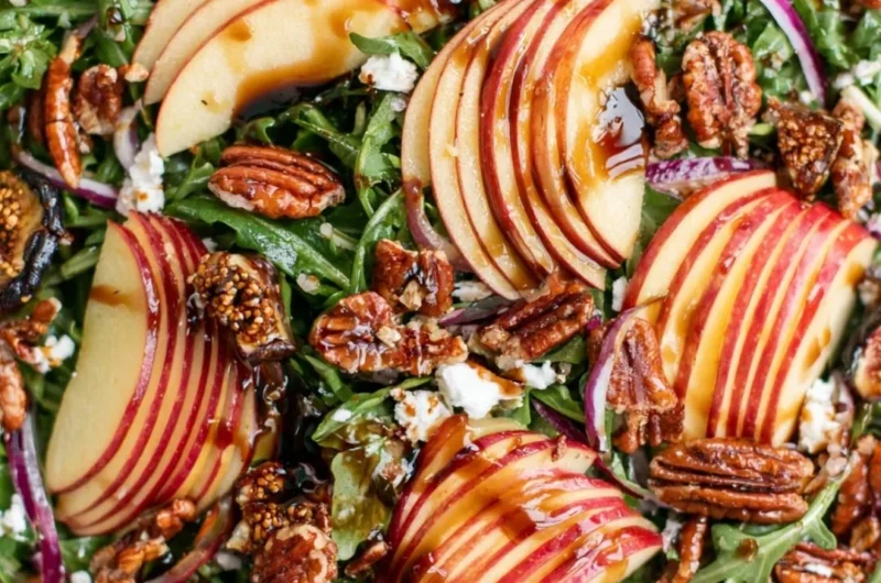 Delicious apple arugula salad with fresh ingredients and vibrant colors.