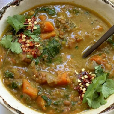 Delicious Sweet Potato Lentil Stew served in a bowl with fresh herbs